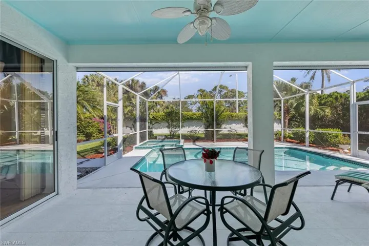 Sunroom featuring a pool and ceiling fan