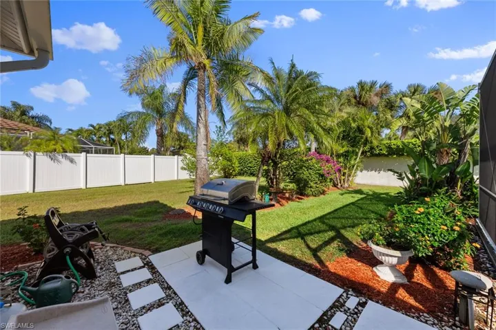 View of patio with a grill