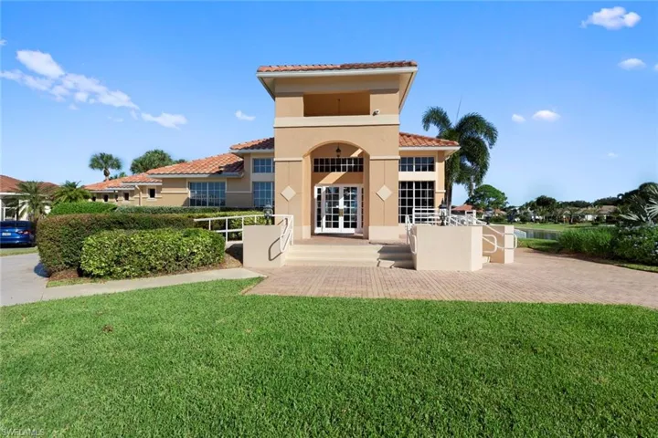 Rear view of property with a lawn and french doors
