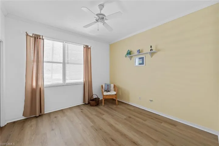 Unfurnished room with ceiling fan, crown molding, and light hardwood / wood-style flooring