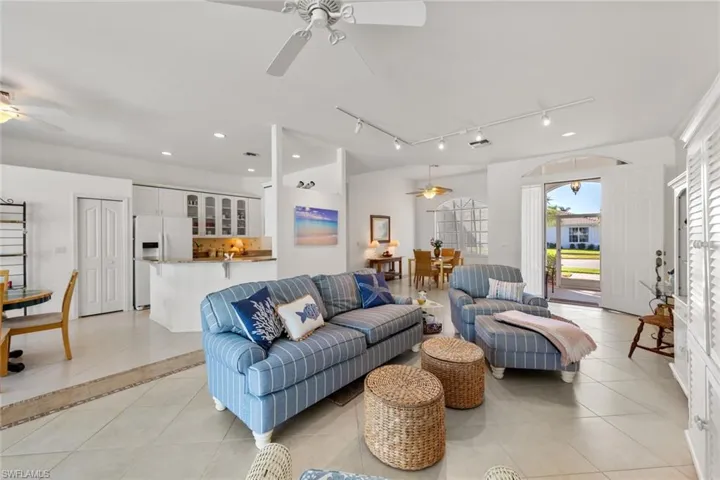 Living room featuring ceiling fan and light tile patterned floors