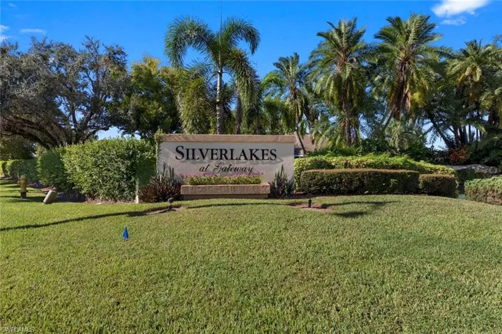 Community / neighborhood sign with a yard