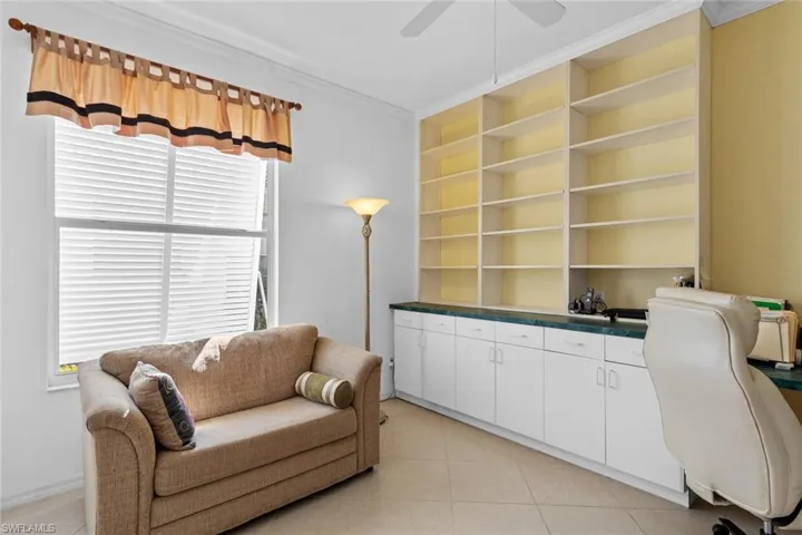 Office featuring ceiling fan, crown molding, and light tile patterned flooring