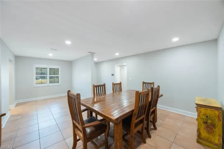 Dining space featuring light tile patterned floors, recessed lighting, and baseboards