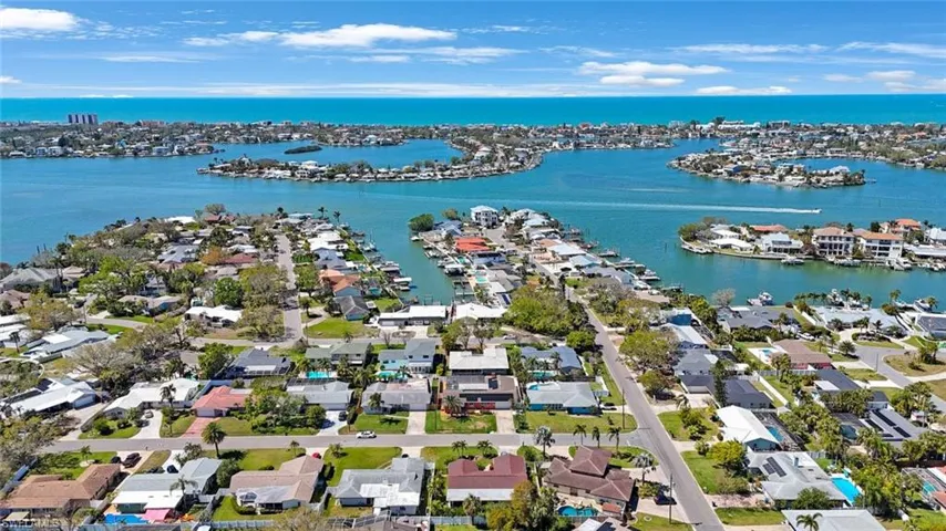 Birds eye view of property with a water view