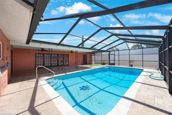 Pool featuring a ceiling fan, a lanai, and a patio area