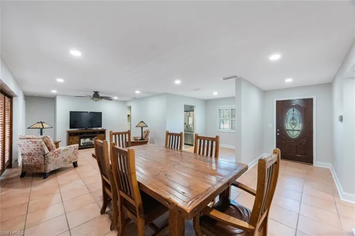 Dining space featuring light tile patterned floors, recessed lighting, and visible vents