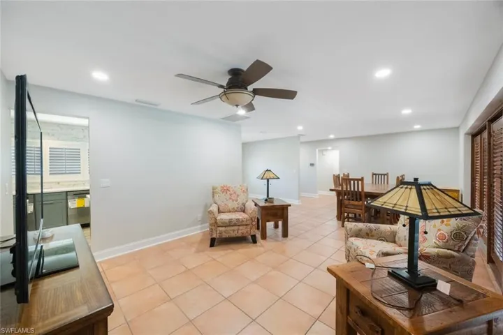 Living room featuring visible vents, baseboards, ceiling fan, light tile patterned floors, and recessed lighting