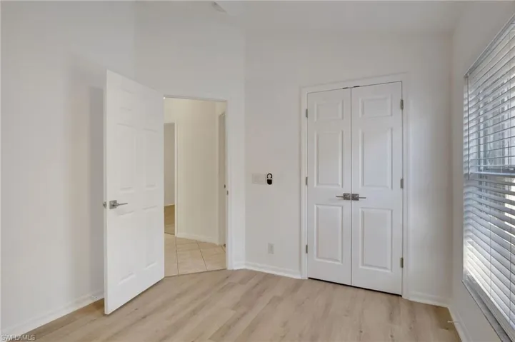 Unfurnished bedroom with a closet and light wood-type flooring