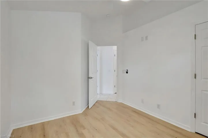 Empty room with light hardwood / wood-style floors