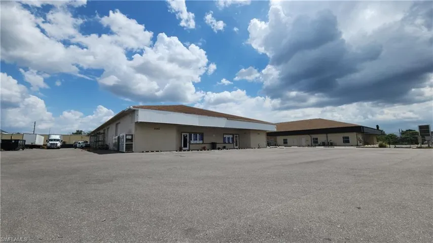View of building exterior with uncovered parking