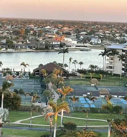 Aerial view at dusk of a water view and a residential view