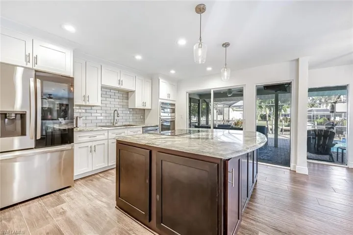 Kitchen with Natural Light, 2-Tone Cabinets, Large Quartz Island