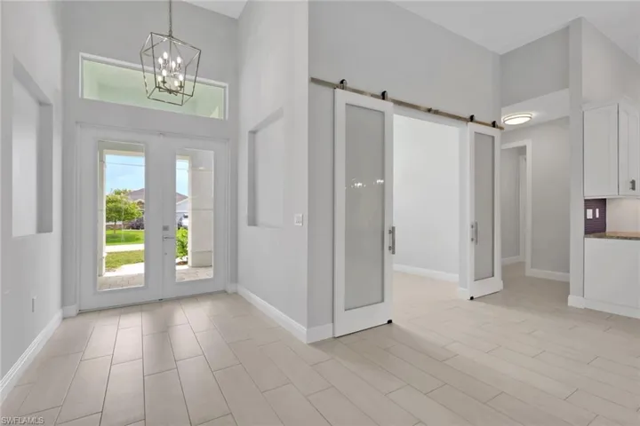 Entry and office/den with glass bar doors