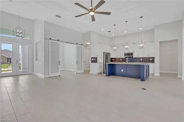 Great room and Island kitchen with granite counters, classic white shaker style cabinets with crown molding and crown molding.