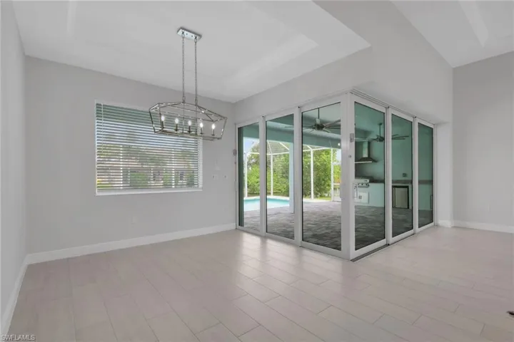Dining area and 90 degree sliding glass doors to the pool/lanai area