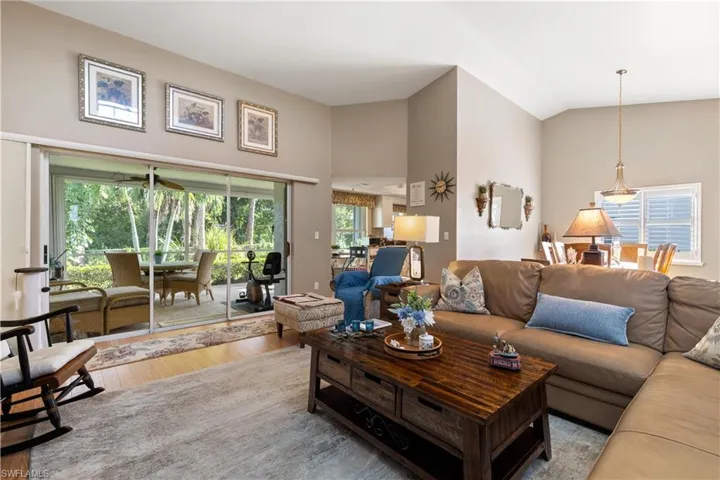 Living room featuring light wood-type flooring and high vaulted ceiling