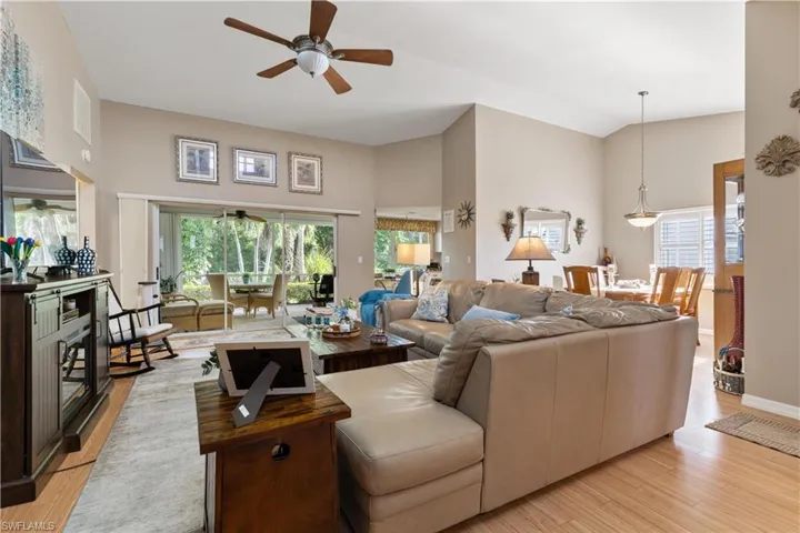 Living room with a healthy amount of sunlight, ceiling fan, and light wood-type flooring