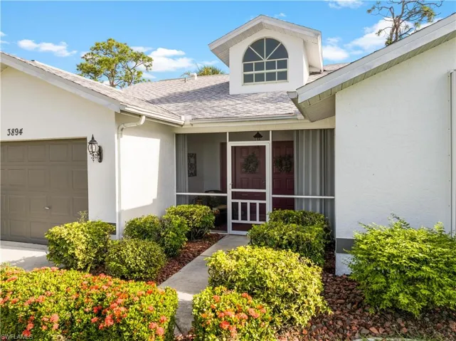 Doorway to property with a garage