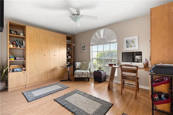 Office area with ceiling fan and light wood-type flooring