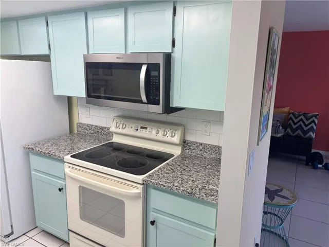 Newly refreshed kitchen with grantie tops and tile backsplash