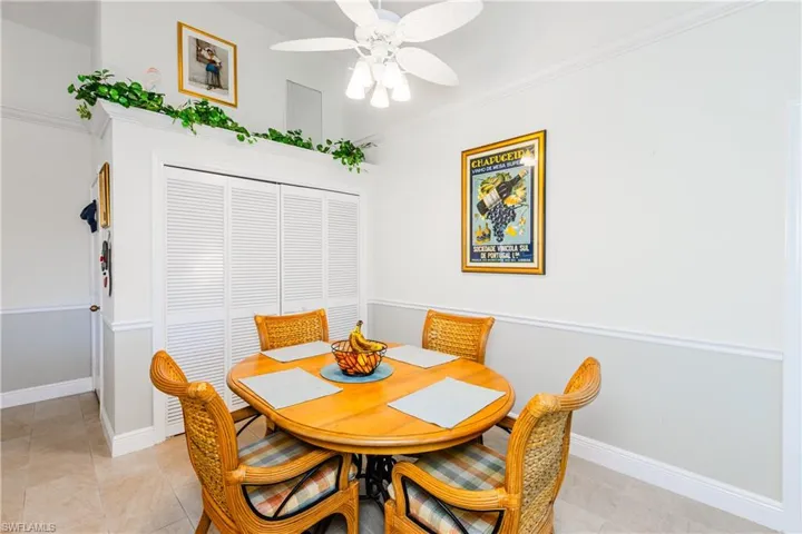Dining area with ornamental molding and ceiling fan