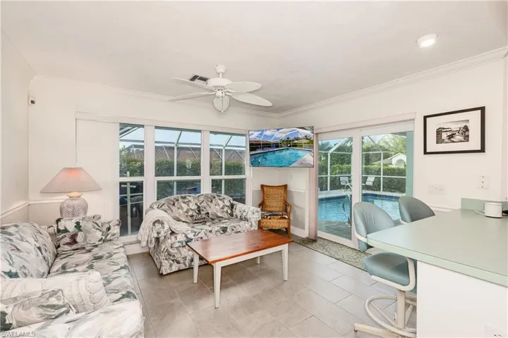 Bedroom featuring access to exterior, ornamental molding, and ceiling fan