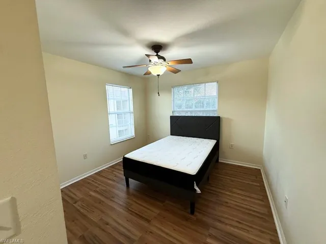 Bedroom featuring dark wood-style flooring and a ceiling fan