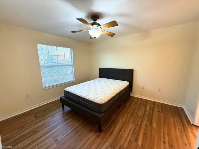 Bedroom featuring dark wood finished floors and a ceiling fan