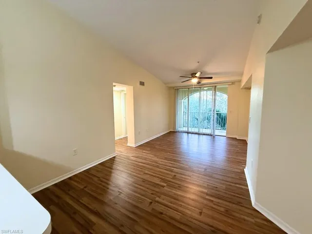 Unfurnished room featuring dark wood finished floors and a ceiling fan