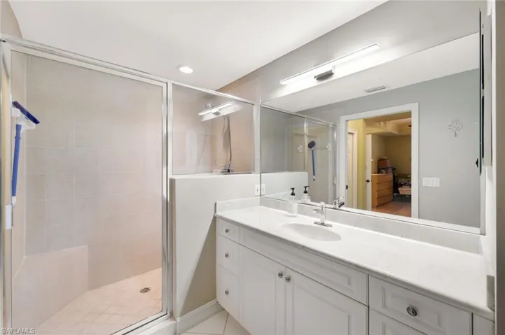 Full bathroom with vanity, a stall shower, recessed lighting, and light tile patterned flooring