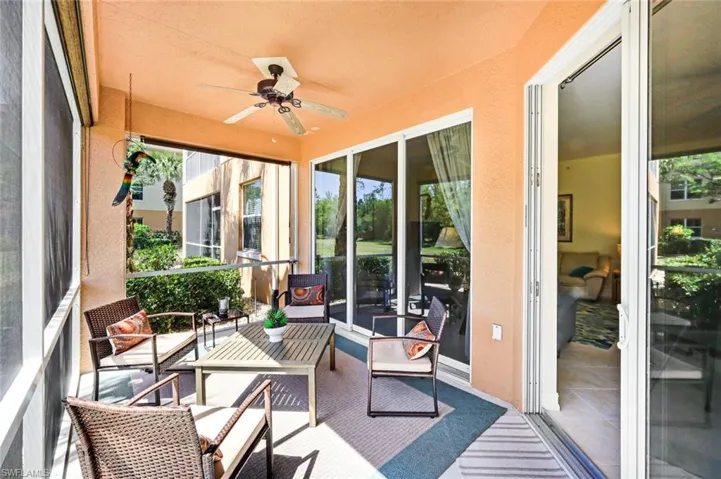 Sunroom with a ceiling fan and an outdoor living space