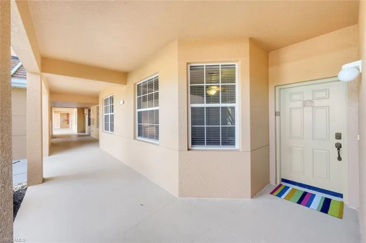 Entrance to property with stucco siding