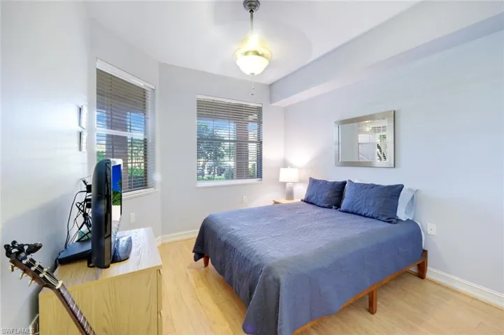 Bedroom with light wood finished floors and baseboards
