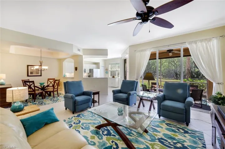 Tiled living room with a chandelier and a tray ceiling