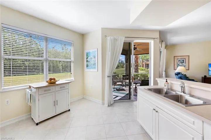 Kitchen featuring white cabinets, light tile patterned floors, and light countertops