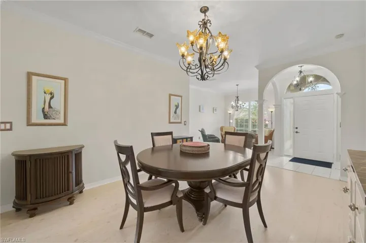 Dining or Living room with wall of sliders to expanded lanai