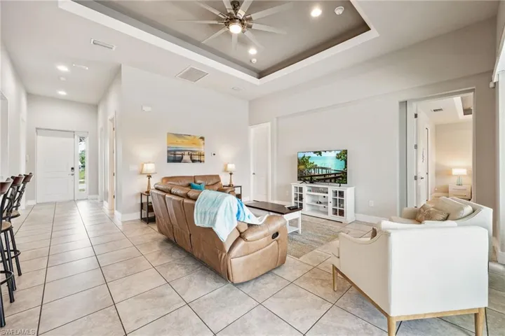 Open-concept living area featuring large format tile flooring throughout
