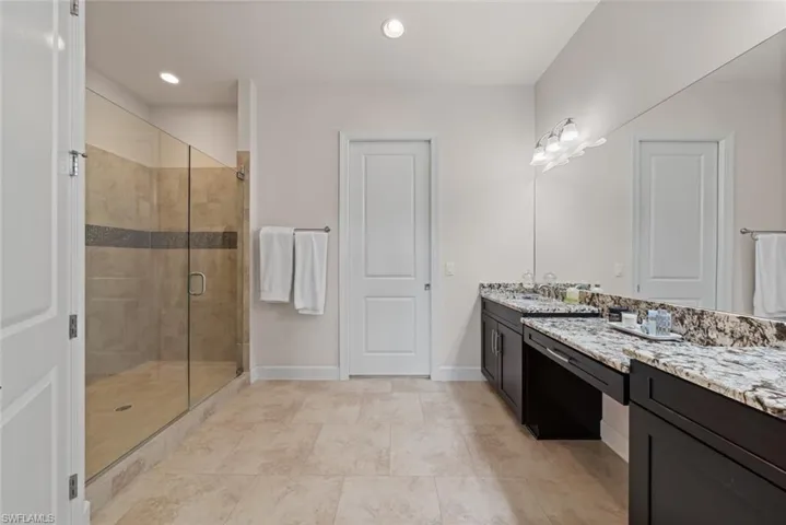 Bathroom featuring vanity and an enclosed shower