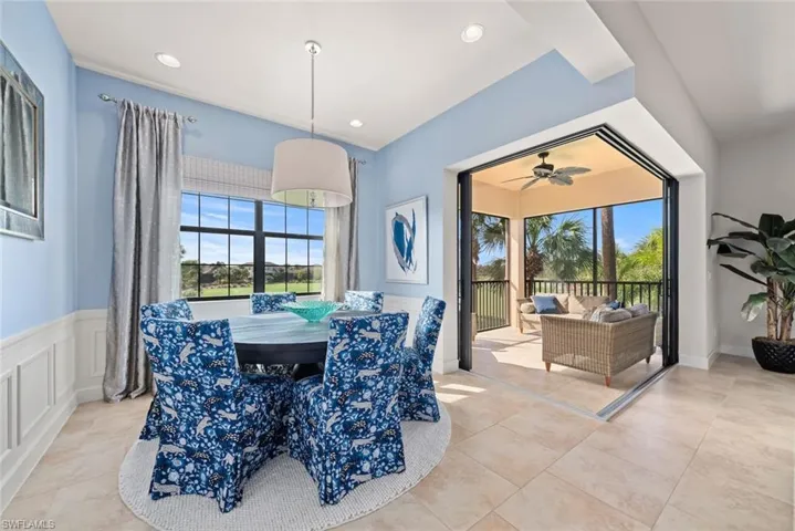 Tiled dining room featuring ceiling fan
