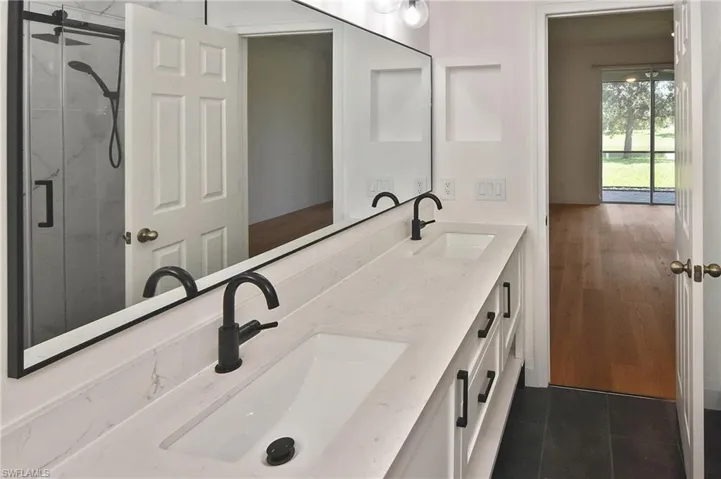 Primary ensuite with custom floating double sink vanity with plenty of storage