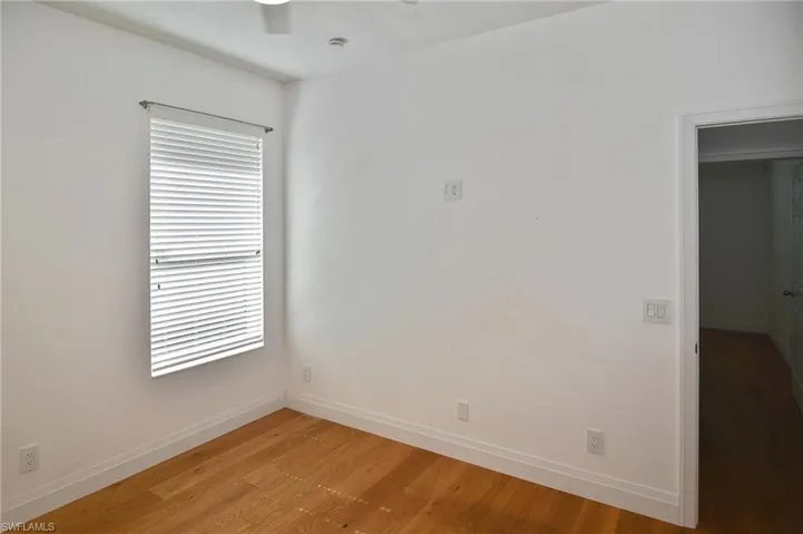 The large window in this Guest Bedroom offers plenty of natural light