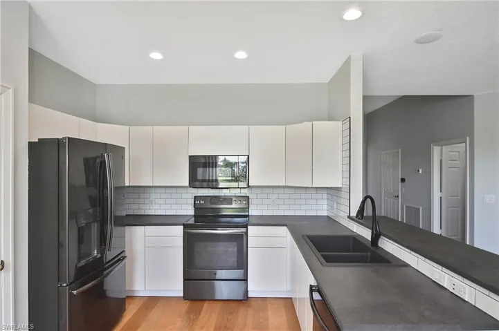 The kitchen has a large breakfast bar