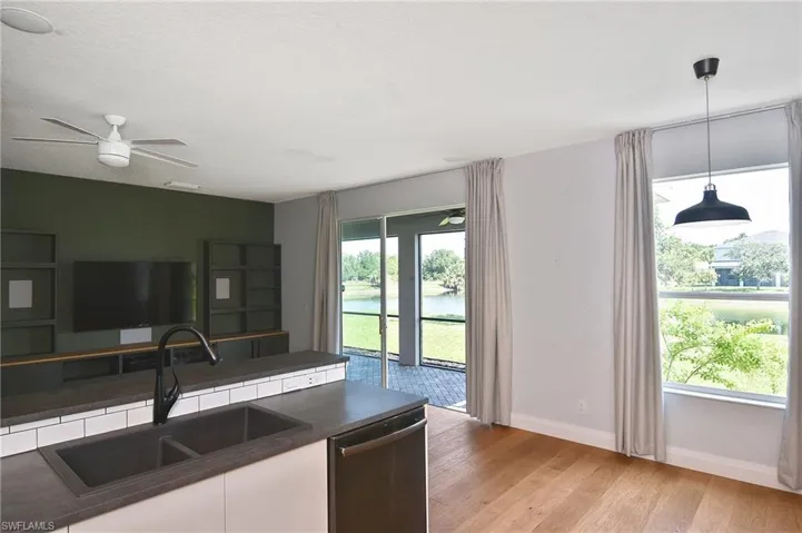 Sliders and large window offer a gorgeous view of the lake and green space and provides plenty of natural light