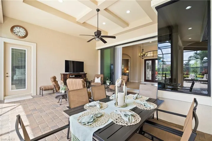 View of large covered lanai  featuring ceiling fan