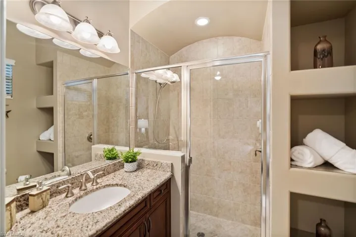 Bathroom with a shower with door and vanity