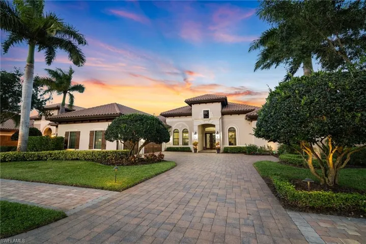 Contemporary style home featuring a lawn and long driveway