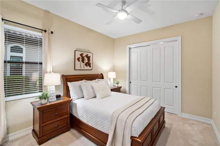 Carpeted bedroom featuring a closet and ceiling fan