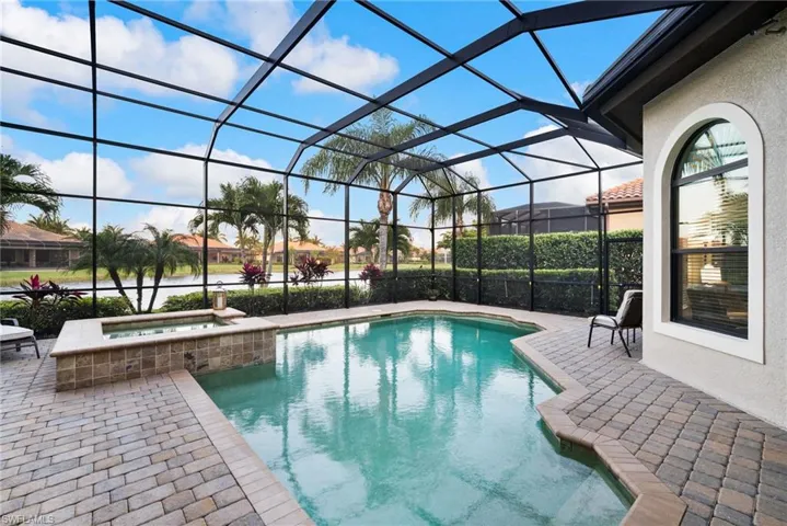 View of pool featuring an in ground hot tub, a patio area, and screen enclosure