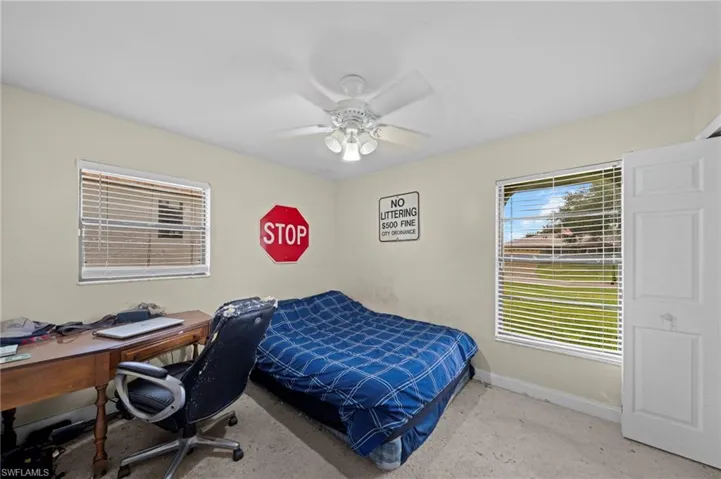 Bedroom featuring an office area and a ceiling fan
